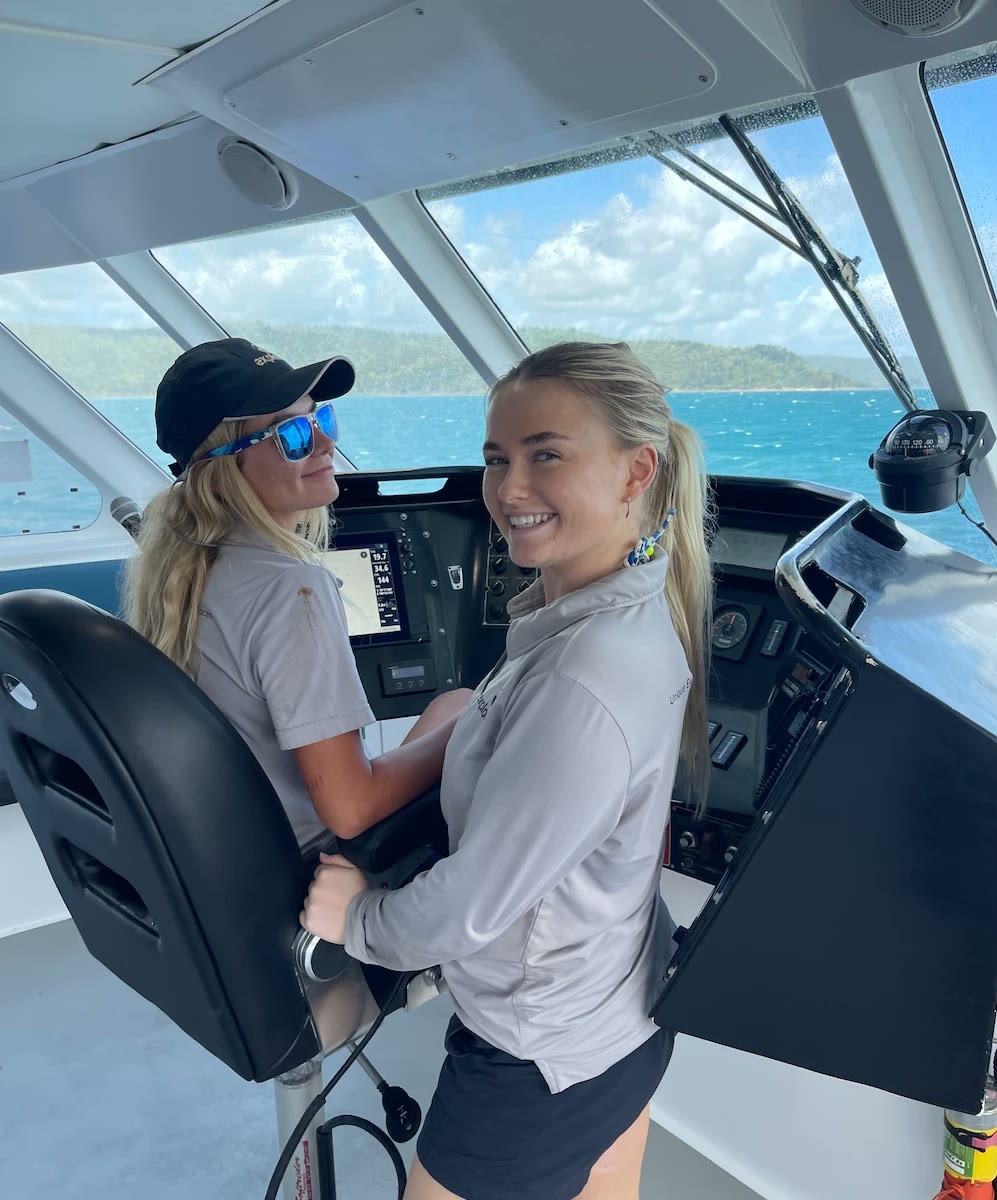 Zoe at the helm of a boat during her many-jobs years on the water