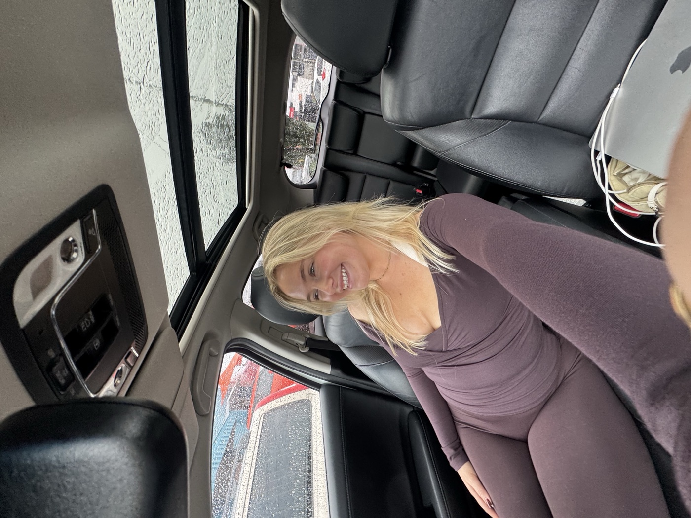 Zoe laughing in the back of a car, newly arrived in Perth